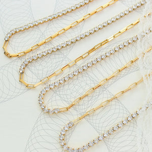 Gold pavé chain necklace with alternating link and crystal sections.