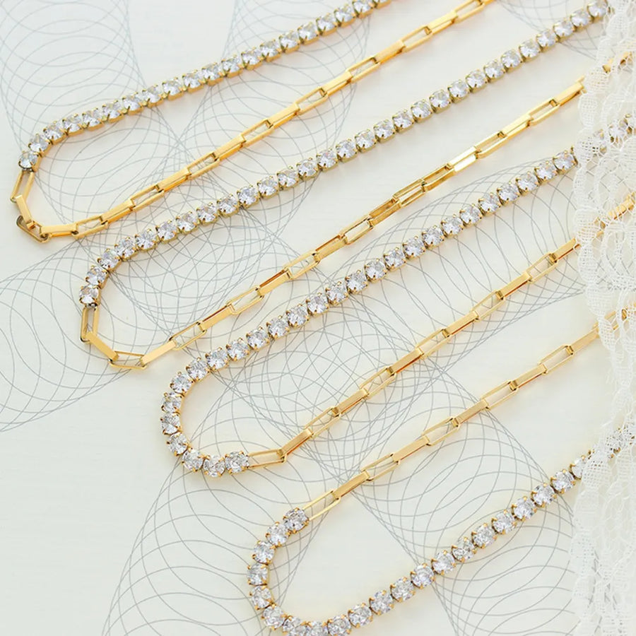Gold pavé chain necklace with alternating link and crystal sections.