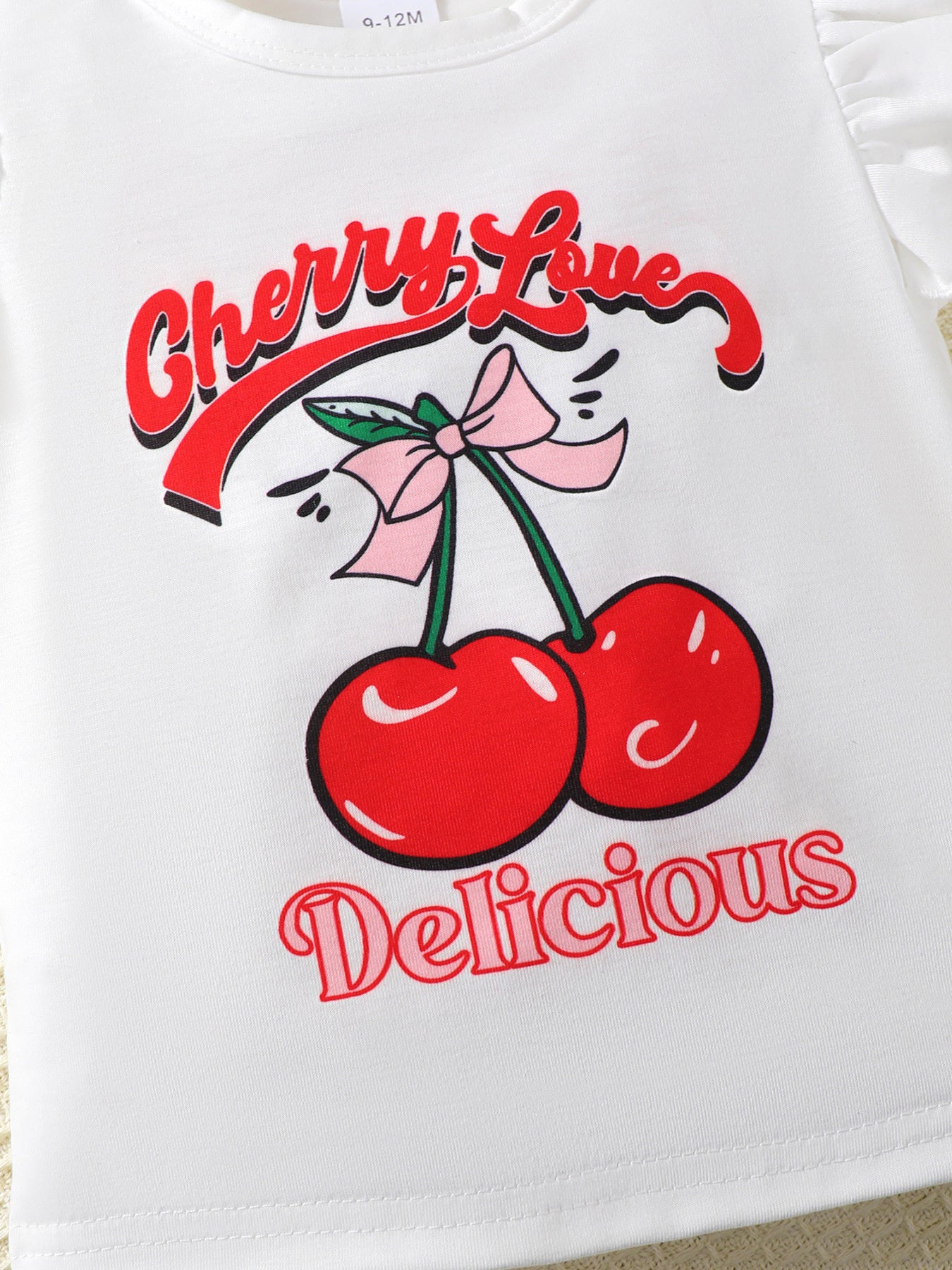 White t-shirt with cherry graphic and "Cherry Love Delicious" text