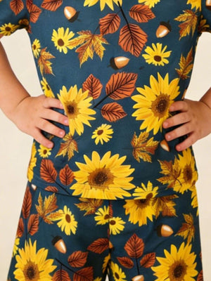 Toddler set with sunflowers, acorns, and autumn leaves pattern on dark blue fabric.