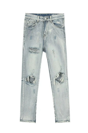 Distressed knee-slit light wash denim trousers with ripped details.