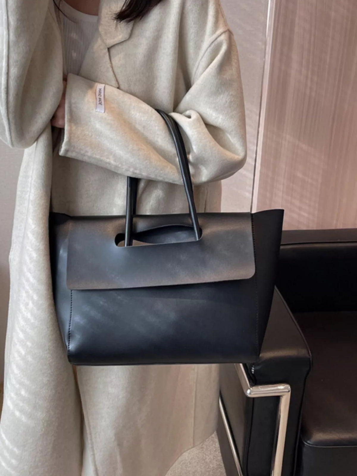 Black PU leather tote shopper bag with a sleek, modern design and top handles.