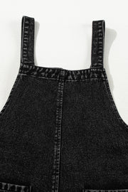 Black denim culotte overalls with distressed details and adjustable straps.