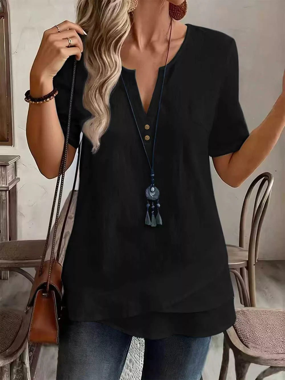 blouse in black featuring notched neckline and relaxed fit