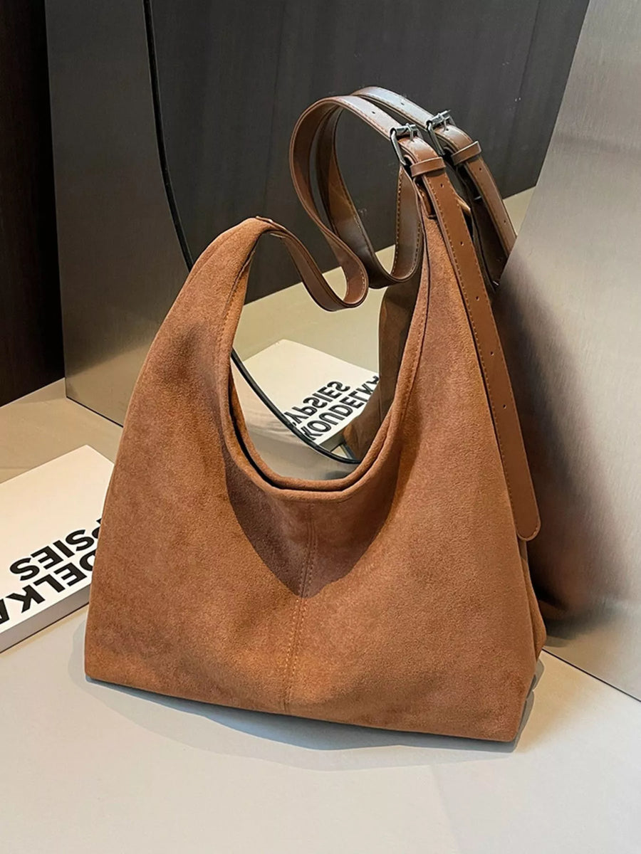 Brown suede hobo bag with adjustable strap and silver buckle detail.