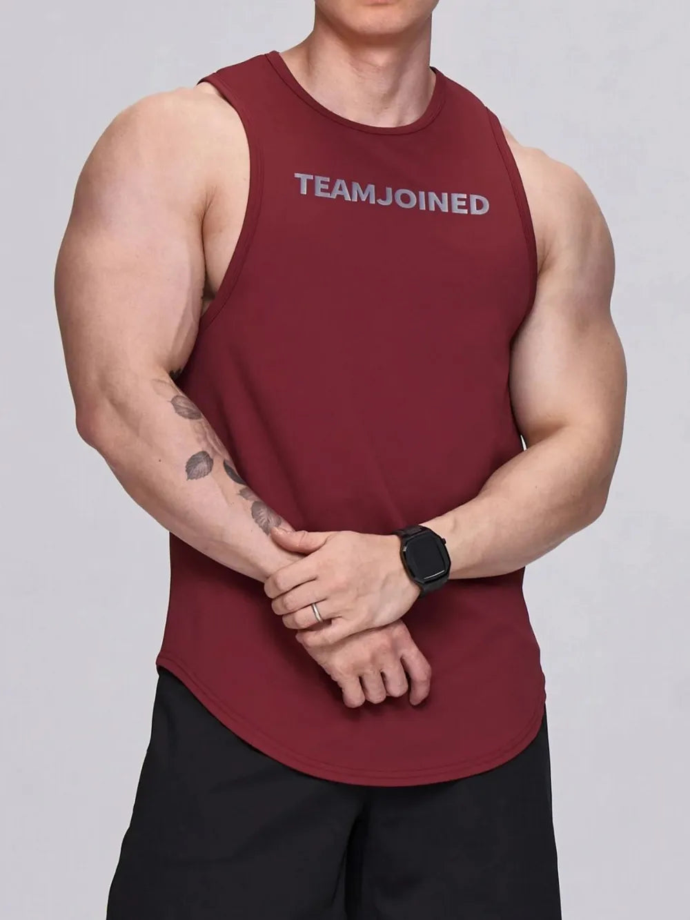 Burgundy performance tank top with TEAMJOINED logo, curved hem, and crew neck.