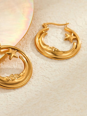Gold earrings featuring crescent moon design and celestial