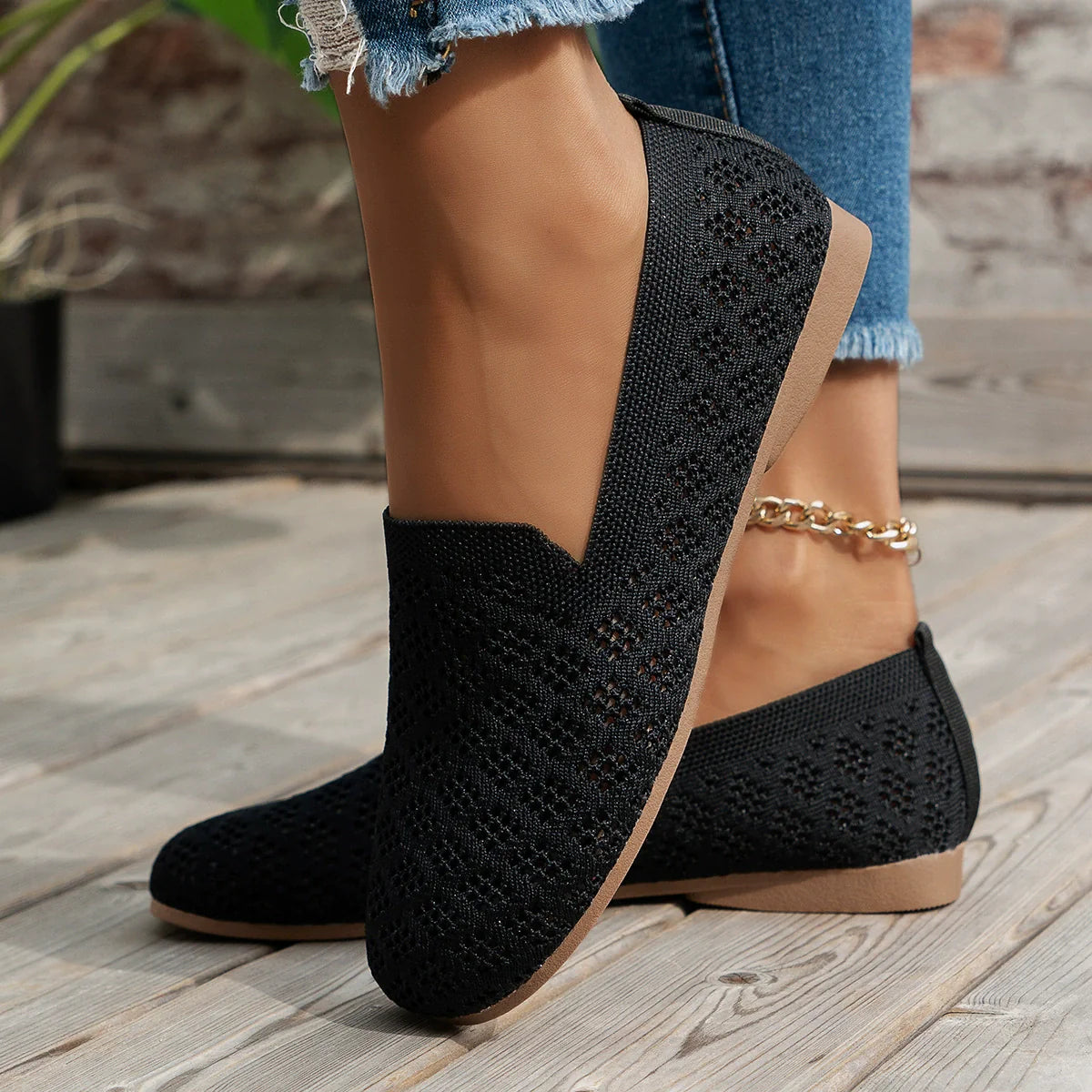 Black diamond knit loafers with a slip-on design and tan sole.