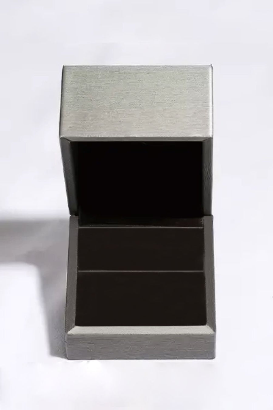 Open jewelry box with brushed silver lid and dark interior