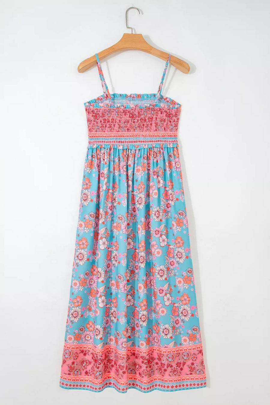 Bohemian floral maxi dress with smocked pink bodice and blue floral skirt.
