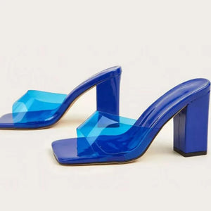 Blue lucite block heel mule sandals with clear straps.