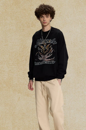 Black oversized sweatshirt with "Miracle" graphic and angelic design.