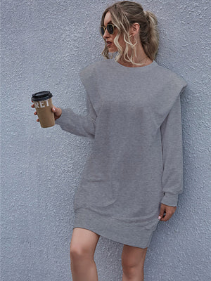 Grey sweatshirt mini dress with padded shoulders and front pocket detail.