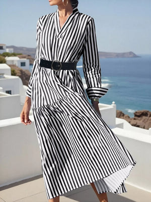 Notched long-sleeve midi dress in black and white stripe with a tiered skirt and belted waist.