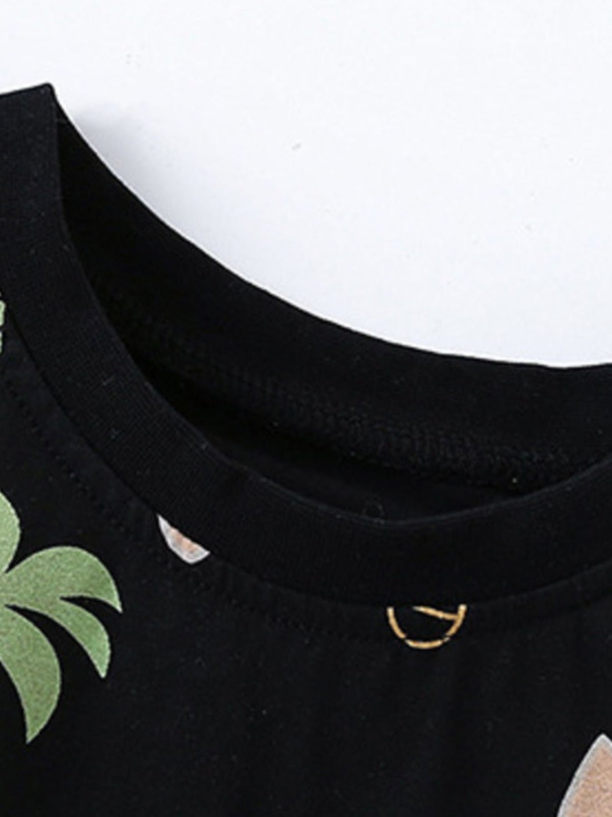 Black cotton baby boys' tee with tropical palm tree print and gold detail.