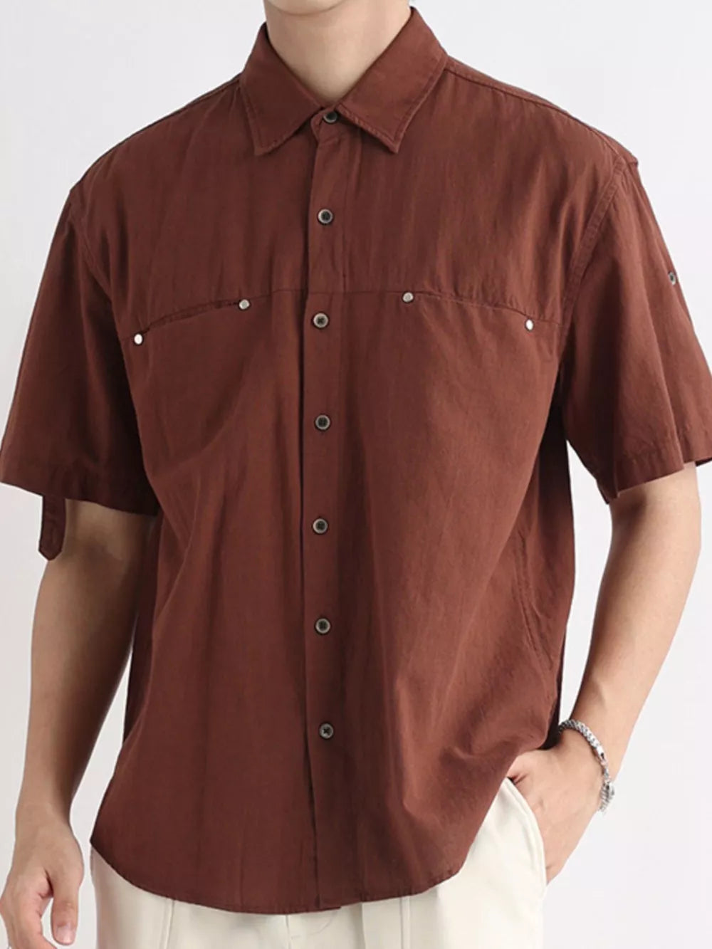 Brown relaxed-fit cotton button-down short-sleeve overshirt with chest pockets.