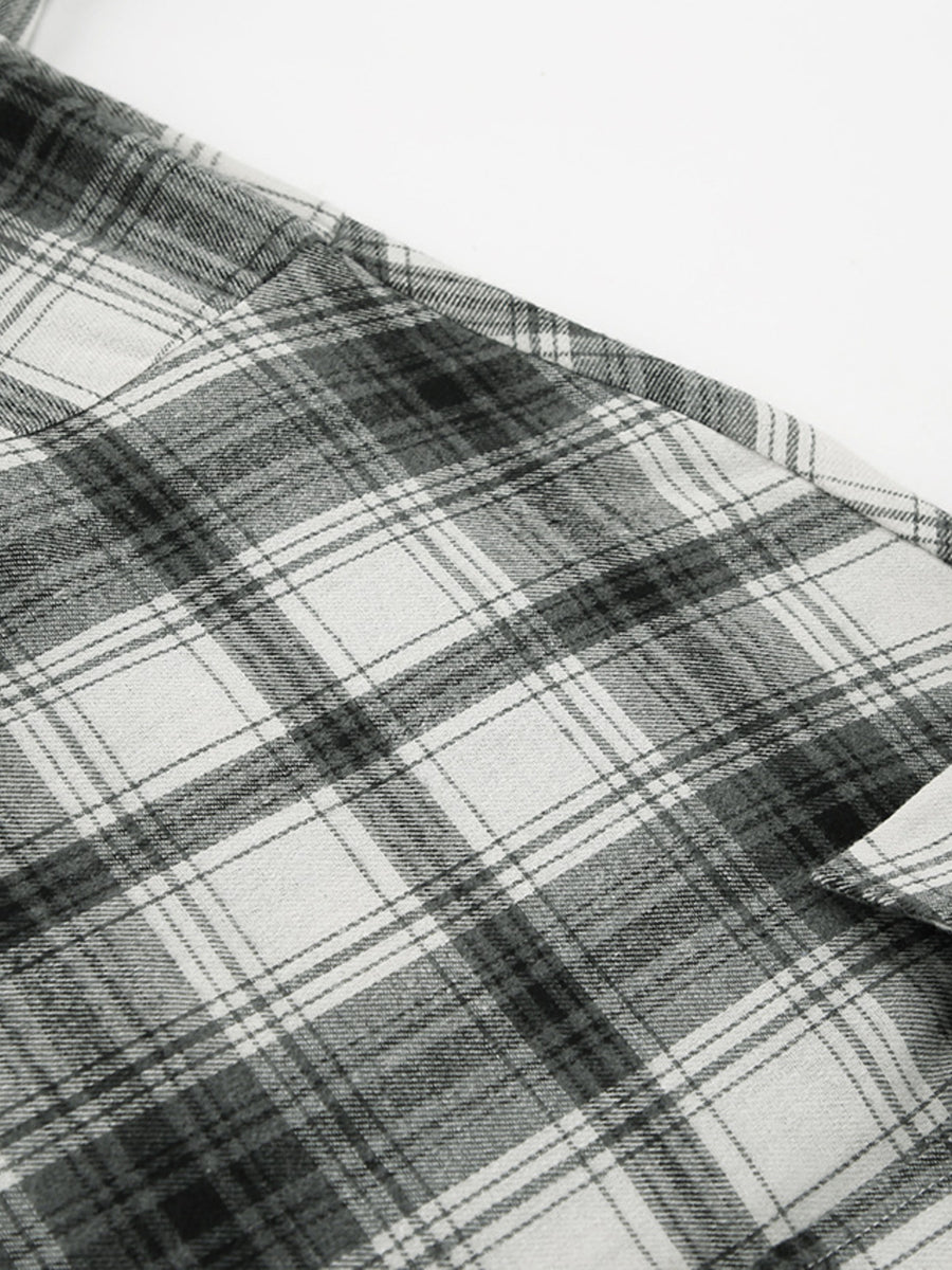 Button-up long sleeve shirt in black and white plaid cotton.