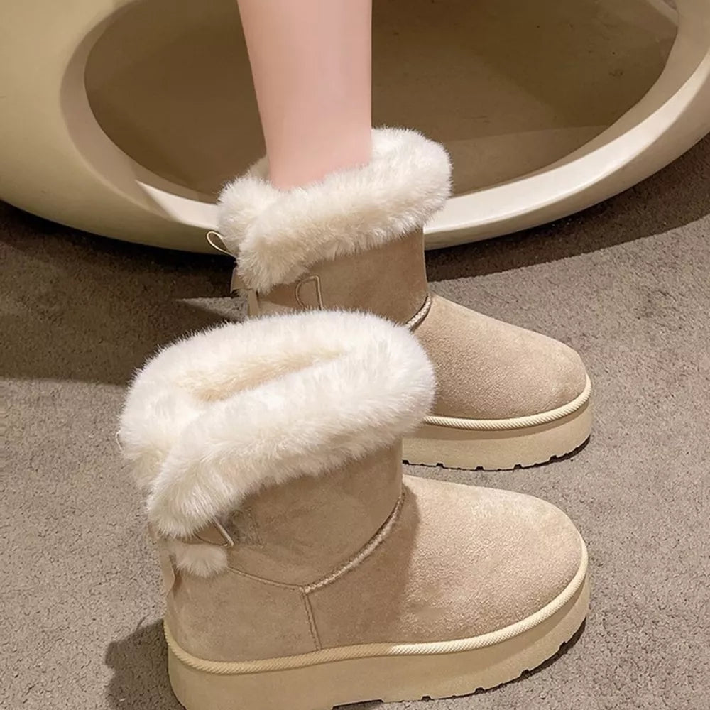 Beige suede round-toe boots with fluffy white trim and platform sole