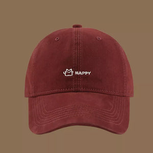 Wine red cotton baseball hat with embroidered cat and happy text detail.