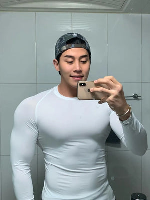 White performance long sleeve tee with crew neck, form-fitting cut.