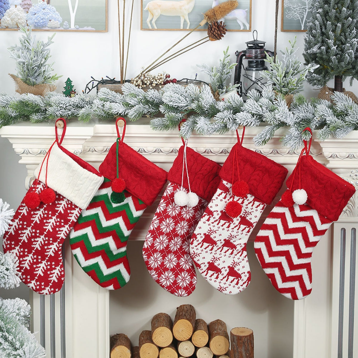 Cable knit Christmas stockings in red, white, and green with snowflake, chevron, and reindeer patterns.