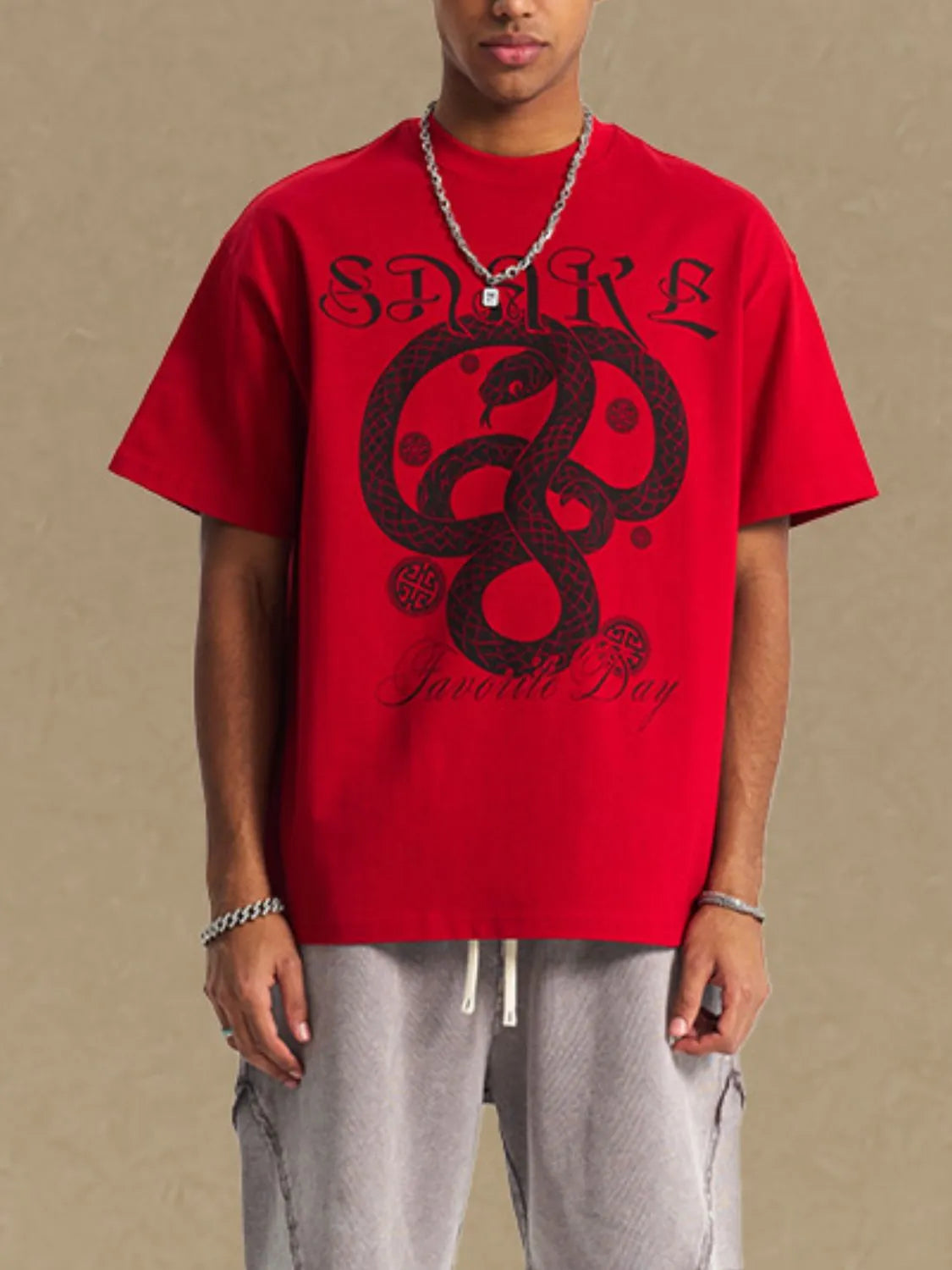 Red oversized tee with black serpent graphic and text detail