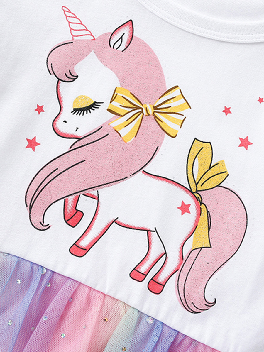 White cotton toddler dress with unicorn graphic, yellow bows, and rainbow tulle skirt.