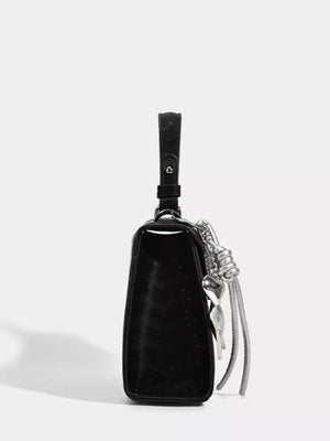 Black mini pu leather tote with embossed pattern and silver buckle detail.