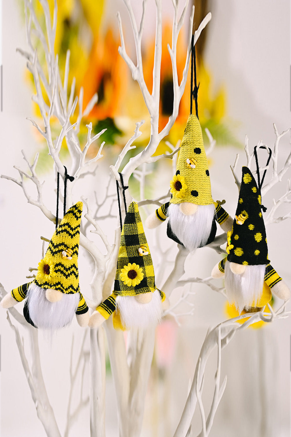Bee-themed gnome ornaments in yellow with black accents, sunflowers, and bumblebee details.