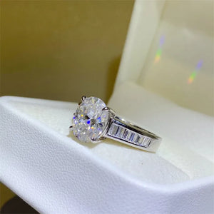 Silver oval cut diamond ring with baguette band detail