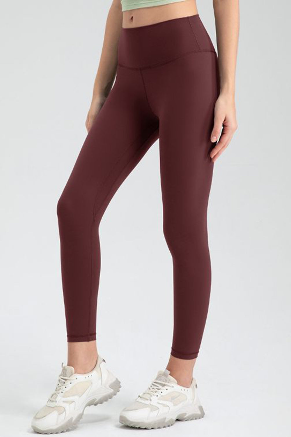 Wine high-waist performance leggings with sculpted seams and a smooth finish.