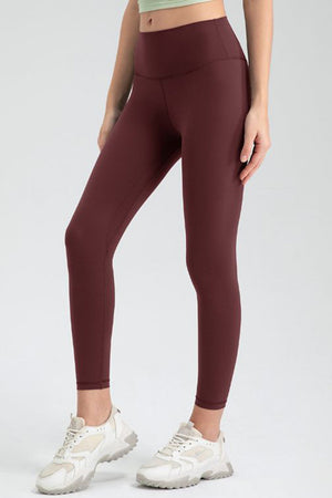 Wine high-waist performance leggings with sculpted seams and a smooth finish.