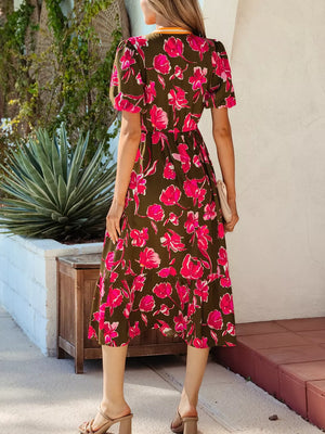Print split neck dress with short sleeves and a ruffled hem, featuring a pink floral pattern on olive green.