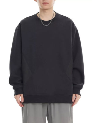 Black oversized cotton crew-neck sweatshirt with textured panel detail.