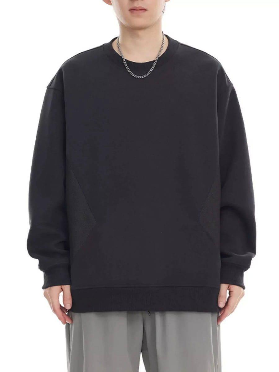 Black oversized cotton crew-neck sweatshirt with textured panel detail.