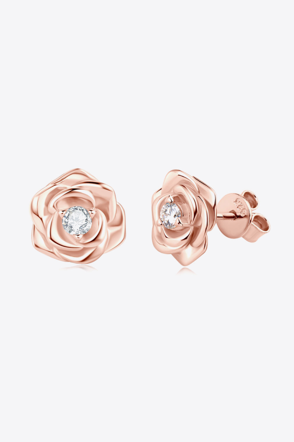 Rose gold rosebud diamond stud earrings with a clear center stone.