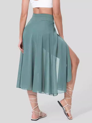 Flowy midi skirt in light blue with shorts liner and high slit, featuring a drawstring waist.