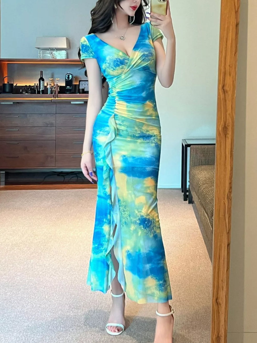 Surplice ruffle maxi dress in blue and yellow tie-dye with a thigh-high slit.