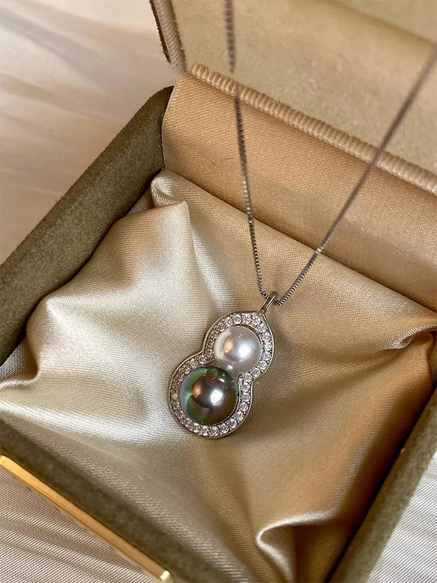 Elegant gourd pendant necklace with pearls and crystals on a box chain.