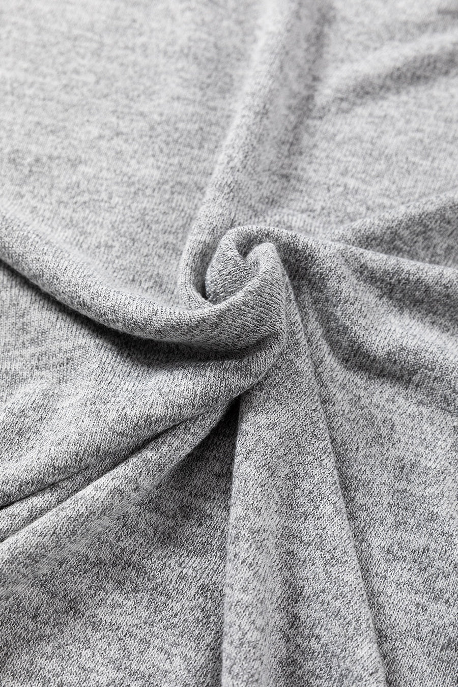 Dark gray slouchy knit top with button details, showing fabric texture.