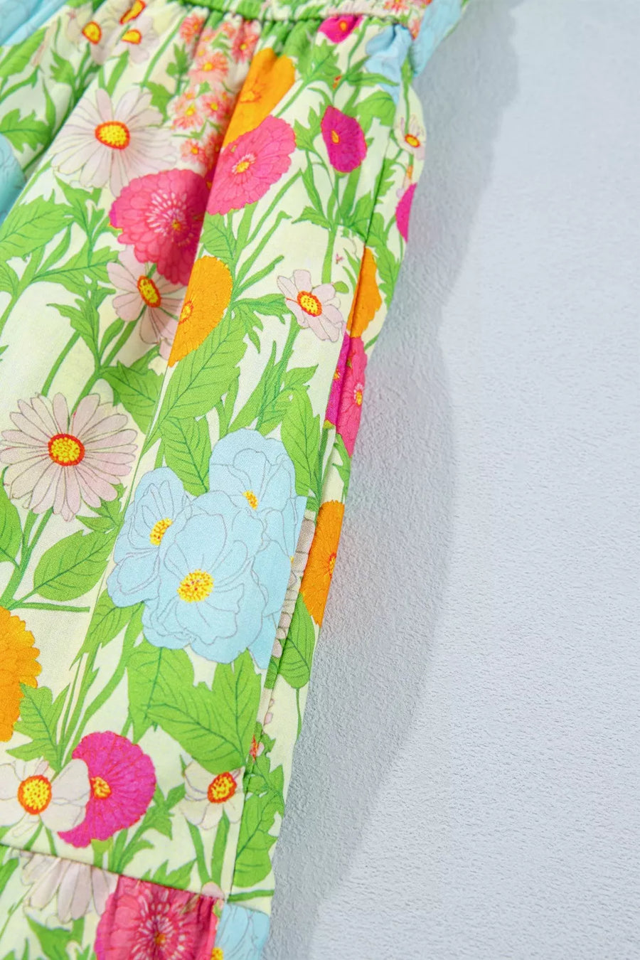 Vibrant floral maxi dress in cotton with ruffled neckline detail and pockets.