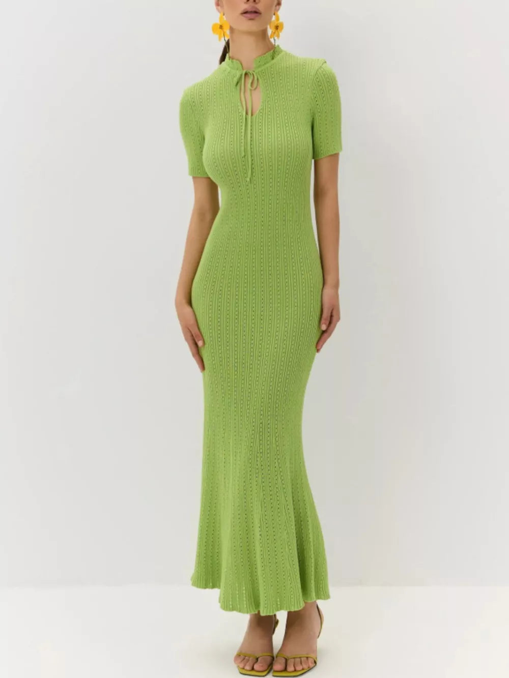 Lime green knitted mermaid dress with short sleeves and a tied neckline.