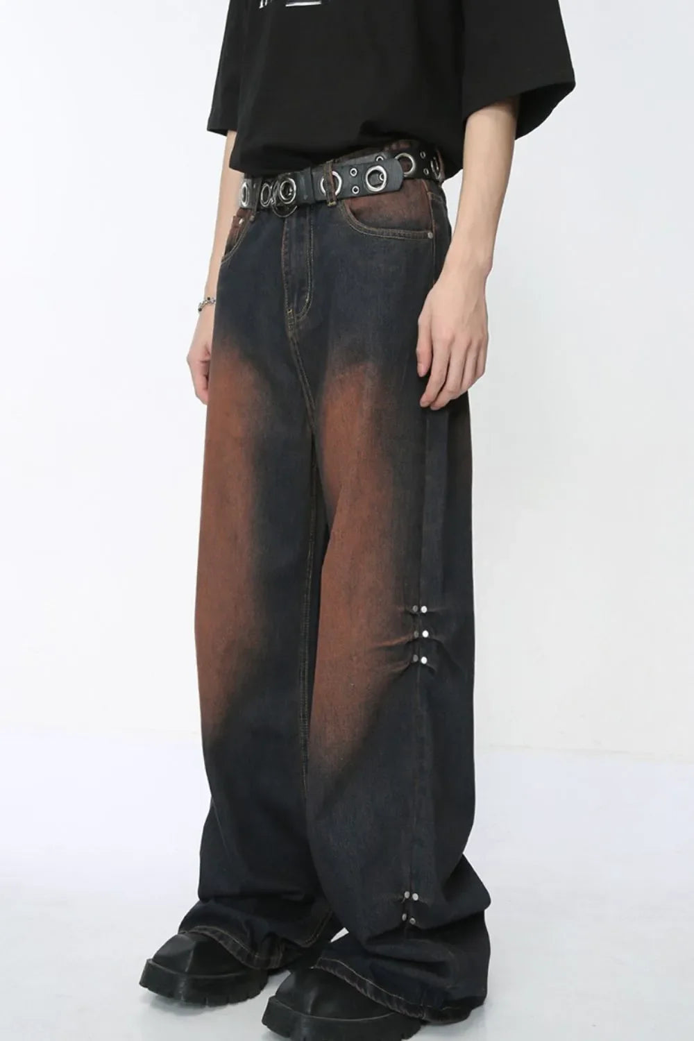 Acid wash flare jeans in dark denim with silver stud details on the side.