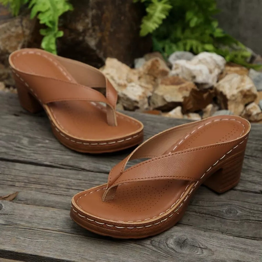 Tan leather toe-post block heel sandals with white stitching detail.