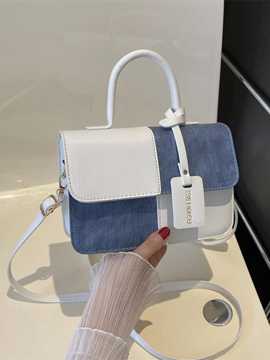 Chic two-tone PU leather crossbody bag in white and blue denim with top handle and strap.