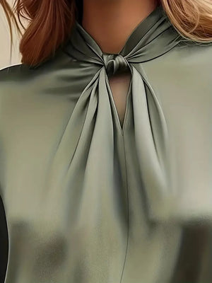 Elegant olive satin blouse with a knotted neckline and cutout detail.