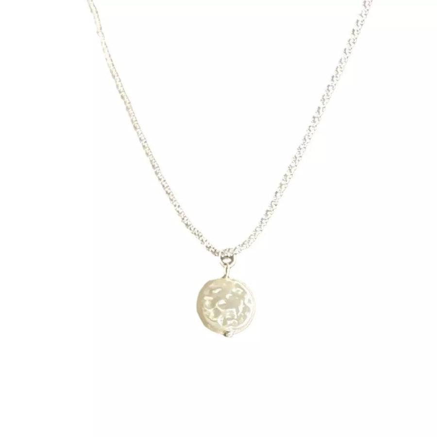Silver chain necklace with a round, textured pearl pendant.