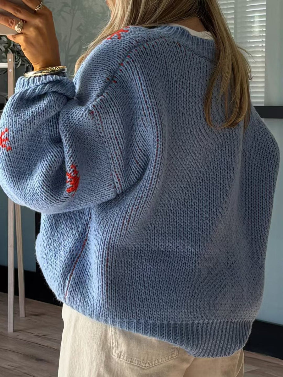 Light blue acrylic knit jumper with red western boot intarsia detail and subtle red stitching.