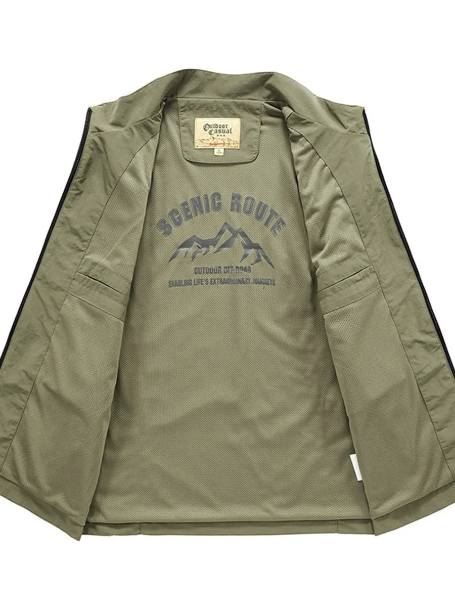 Men's plus size sage green multi-pocket vest, interior view with "Scenic Route" mountain graphic.
