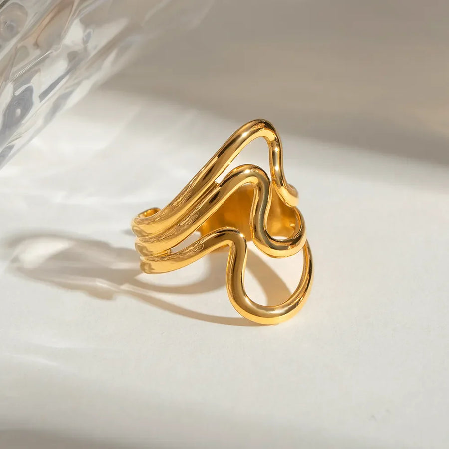 Gold sculptural wave ring with abstract design